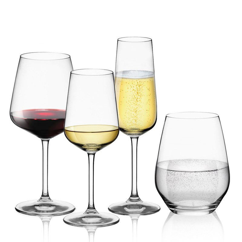 Quattro bicchieri di vetro, uno con vino rosso, uno con vino bianco, uno con spumante e uno per acqua, su sfondo bianco.